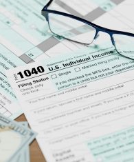 1040 tax document with glasses on a table